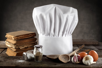 old cookbooks and chef hat