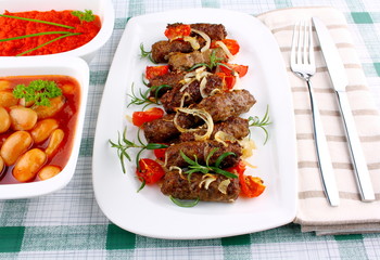 Grilled cevapcici with ajvar and giant white beans