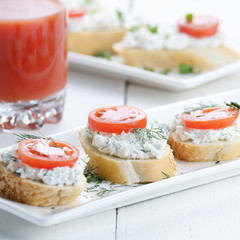 Breakfast of cottage cheese bruschettas and tomato juice