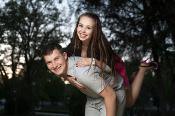 young couple piggybacking in park