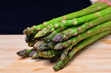 Green asparagus on wood
