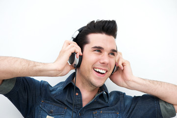 Handsome young man listening to music on headphones