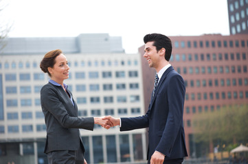 Businessman and business woman greeting with a handshake