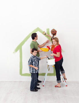 Happy family with kids redecorate their new home