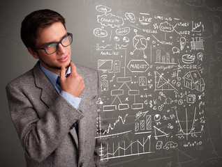 Attractive man looking at stock market graphs and symbols