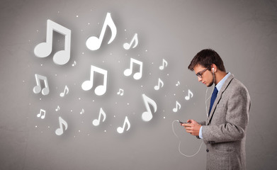 attractive young man singing and listening to music with musical