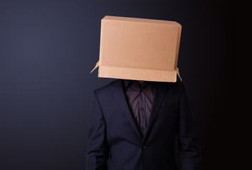 Young man gesturing with a cardboard box on his head