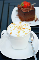 Cup of coffee with a chocolate cake