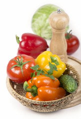 Fototapeta na wymiar Fresh vegetables on a cutting board and a wooden wicker basket