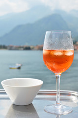 Traditional Italian Spritz cocktail against lake Como, Italy