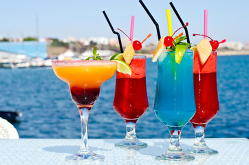 Summer colorful exotic drinks served on the rocks at the seaside