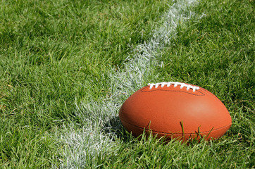 Obraz premium American Football on Natural Grass Field