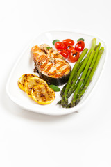 Grilled salmon steak with asparagus and cherry tomatoes