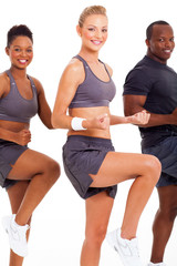 caucasian woman exercising with two friends