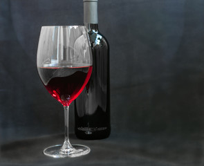 Wineglass with red wine, grey background