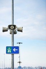 Loudspeaker on pole with hihgway sign