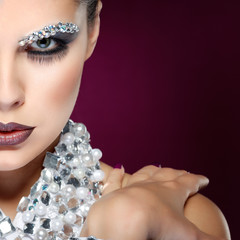 sexual beautiful girl with strasses on face, on a violet 