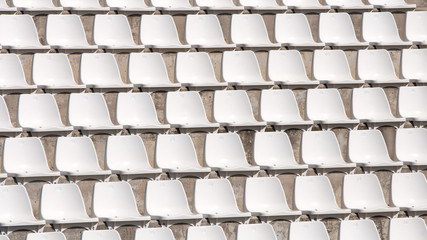 Empty white stadium chairs in a row
