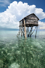 Bajau fisherman's wooden hut on sea water with blue sky