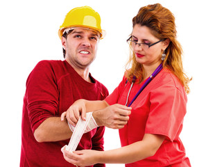 Female doctor/ nurse putting  a bandage to a worker hand, injure