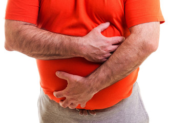 Man holds both hands on his aching stomach