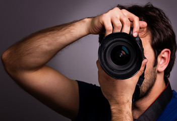 Young man with professional camera