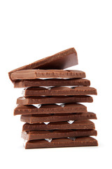 Stack of chocolate pieces on a white background.