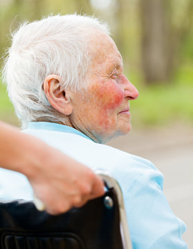 Elderly Woman In Wheelchair Outdoors