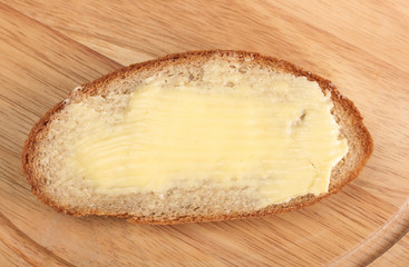 rye bread and butter on wooden board