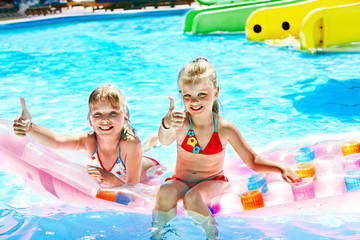 Child on water slide at aquapark.