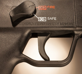 Firing position showing on the safety of an assault rifle with flat black finish - obrazy, fototapety, plakaty