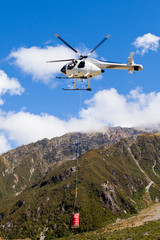 Fototapeta na wymiar Transport helicopter fly over mountain wilderness