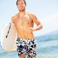 Handsome man surfer fun on summer beach