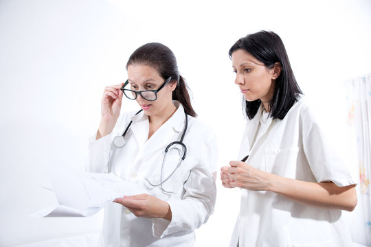 Medical Workers Looking At Documentation