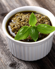 Pesto sauce on a wooden background