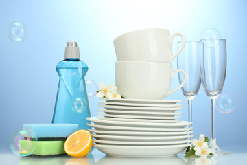 empty clean plates, glasses and cups with dishwashing liquid,