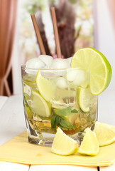 Glass of cocktail with lime and mint