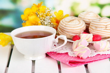 Beautiful composition with cup of tea and marshmallow