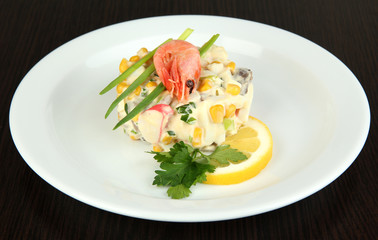 Small portion of food on big plate on wooden table
