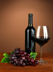 Composition of wine bottle, glass of red wine, grape