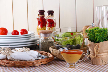 Table setting on checkered tablecloth on wooden background