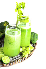 Glasses of green vegetable juice, isolated on white