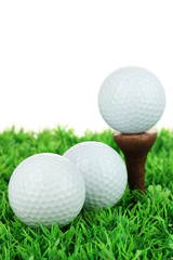 Golf balls on grass isolated on white