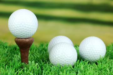 Golf balls on grass outdoor close up