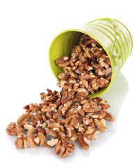 Overturned bucket with nuts isolated on white