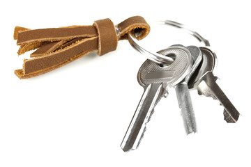 Key with leather trinket isolated on white
