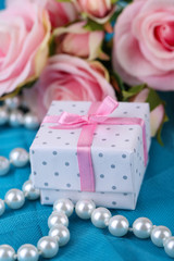 Rose  and gift  on blue cloth