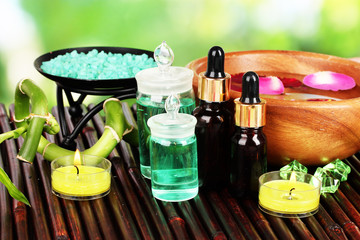 Spa composition with aroma oils on table on bright background