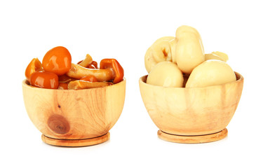 Mushrooms in wooden bowls, isolated on white