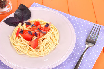 Spaghetti with tomatoes and basil leaves